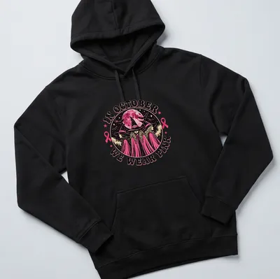 Vintage gothic t-shirt featuring witches and text about wearing pink in October — printed on a unisex hoodie
