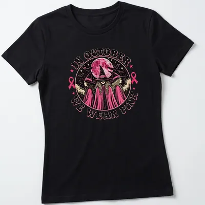 Vintage gothic t-shirt featuring witches and text about wearing pink in October — printed on a women's shirt