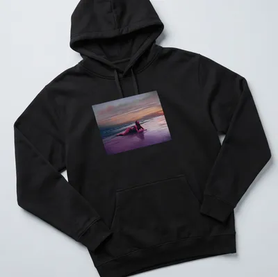 Dreamy surreal print of a woman on a beach at sunset with vibrant colors — printed on a unisex hoodie