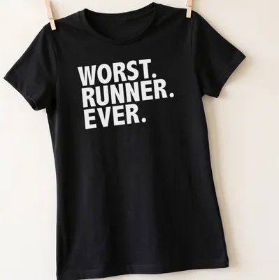 Funny graphic t-shirt depicting struggling runner with humorous text — printed on a women's shirt