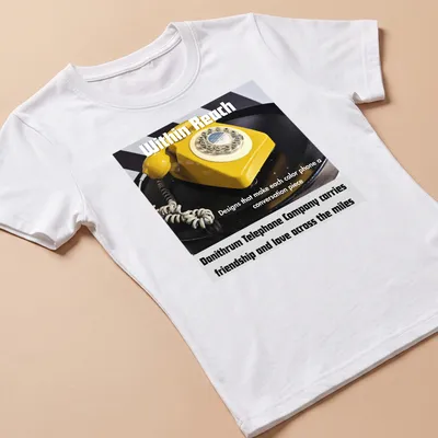 Graphic of a yellow rotary telephone with text about friendship and love — printed on a women's shirt